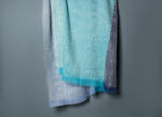 Les Bleus, mohair throw in tones of blues, hanging on a wall