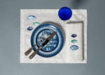 Galets placemat and napkin with blue plate and blue glass