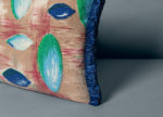 detail of Galets decorative pillow with pebble prints and blue fringe