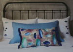 Glaets bed linen with pillow with pebble print and light blue pillow on a bed