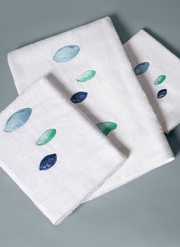Three folded towel with pebbles embroideries in blue and green