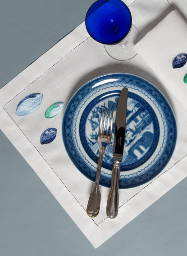 Dietail of Galets table set embroideries with plate, glass and silverware
