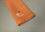 Pumpkin on burnt orange linen napkin